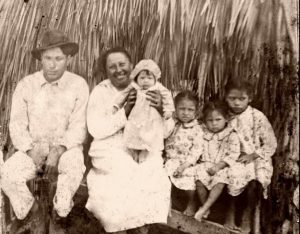 Family in a thatch palmetto camp.